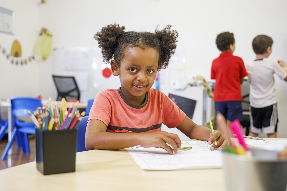 A child colouring a colouring in sheet.