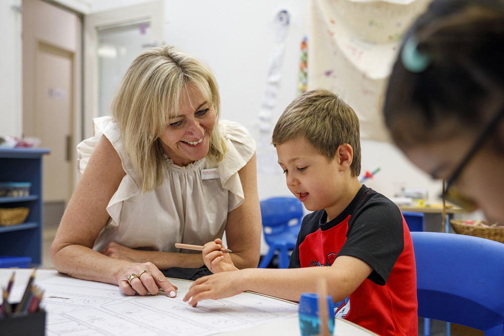 A child and therapist drawing on a worksheet