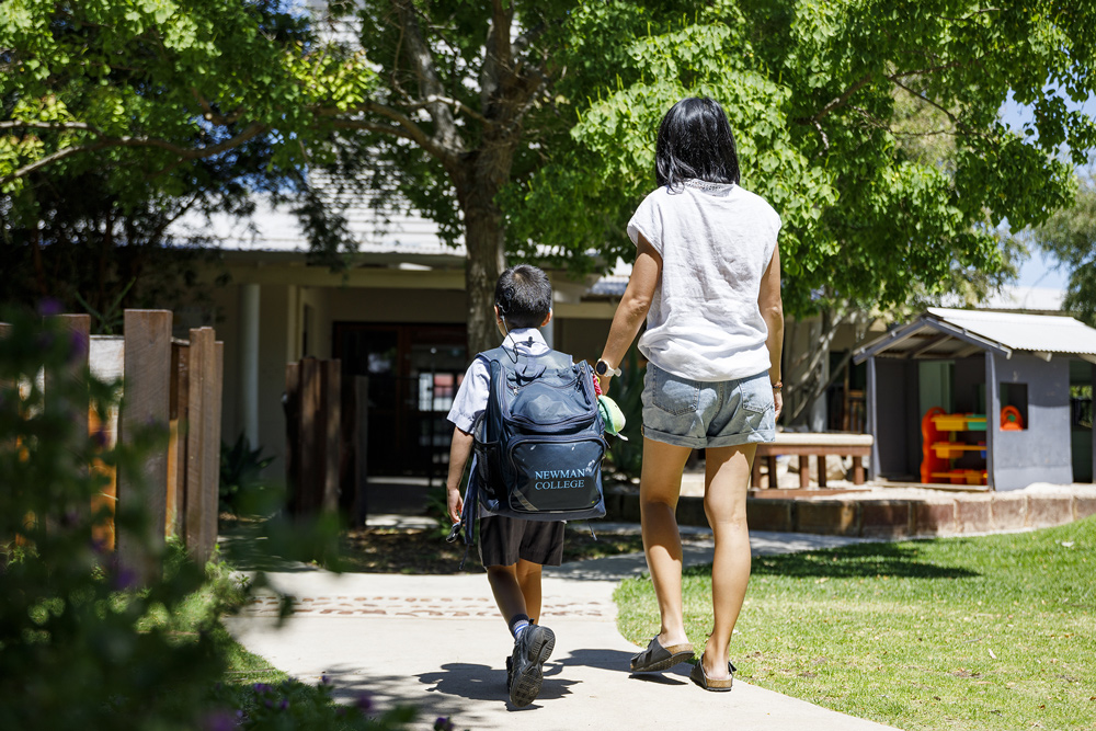 A child and mother walking to school.