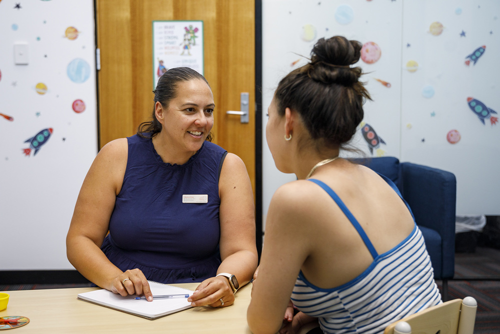 A consultation between a parent and an audiologist.