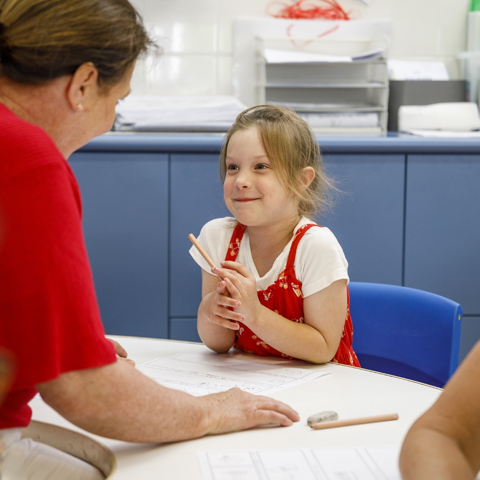 A child and teacher filling in a fun worksheet.